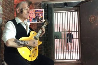 King Crimson’s Robert Fripp Performs Black Sabbath’s “Paranoid” as Wife Toyah Sings and Dances Behind Bars: Watch