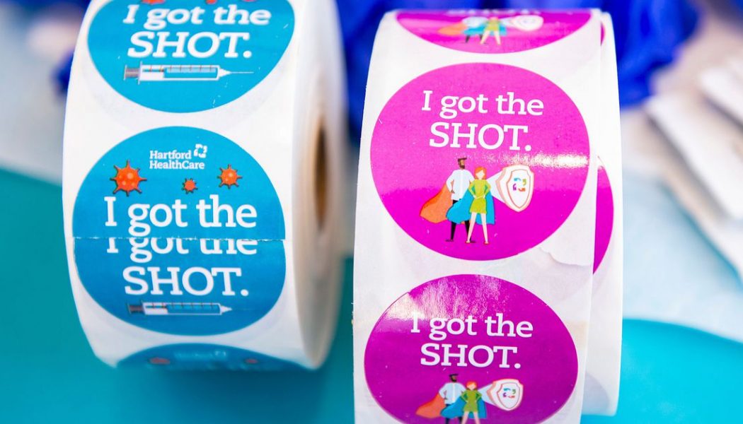 Vaccine centers embrace stickers and selfie stations 