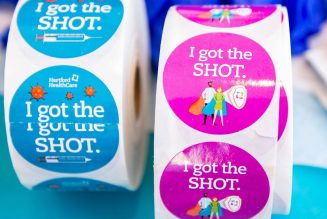 Vaccine centers embrace stickers and selfie stations 