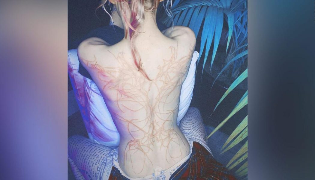 Grimes Shows Off New Tattoo of “Beautiful Alien Scars”