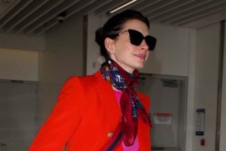 Anne Hathaway’s Airport Outfit Includes Puddle Pants and a Very ’90s Shoe Trend