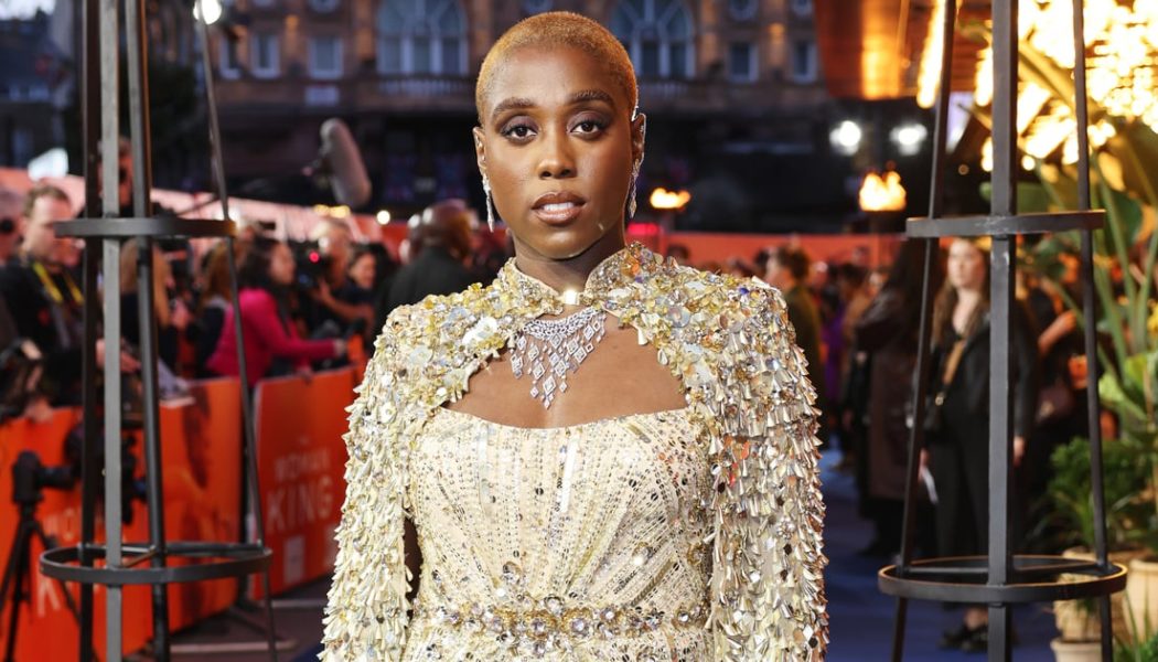 Lashana Lynch Glistens in a Gold Sequinned Cape at “The Woman King” Premiere