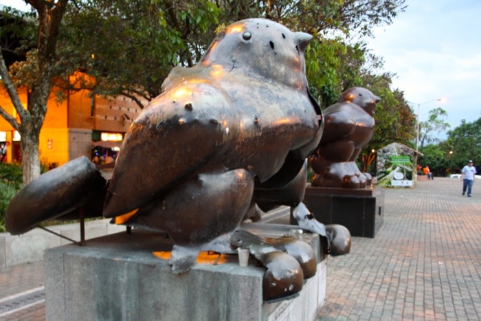 Botero's birds: A deformed sculpture sits next to a newer, perfectly-formed counterpart, representing the two stories of Medellin