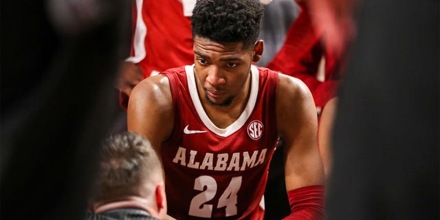 Brandon Miller listens to head coach Nate Oats of the Alabama Crimson Tide during the South Carolina Gamecocks game on Feb. 22, 2023, at Colonial Life Arena in Columbia.