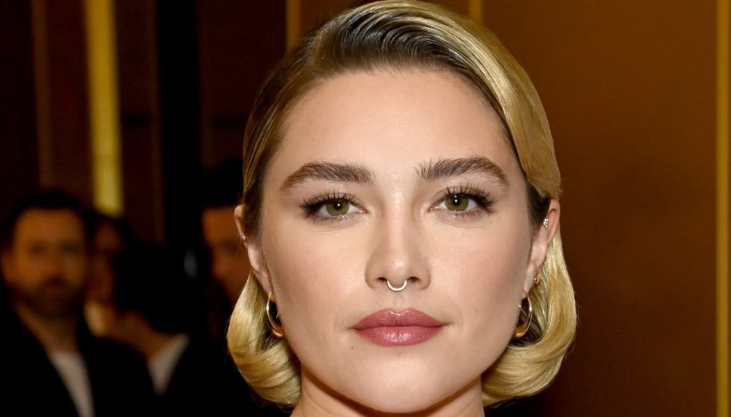 Florence Pugh Is Bringing the Peplum Back in a Red Corseted Gown and Puss in Boots Hat