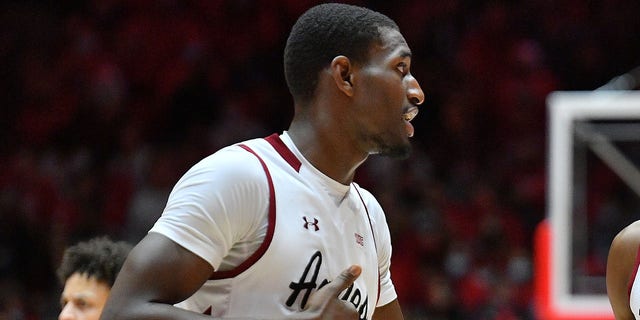 Mike Peake #15 talks to Sir'Jabari Rice #10 of the New Mexico State Aggies during their game against the New Mexico Lobos at The Pit on Dec. 6, 2021 in Albuquerque, N.M.