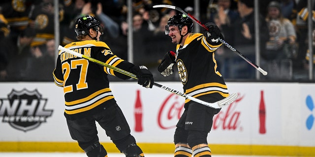 Dmitry Orlov, #81 of the Boston Bruins, celebrates with Hampus Lindholm, #27, after scoring a goal against the Buffalo Sabres during the second period at the TD Garden on March 2, 2023 in Boston.