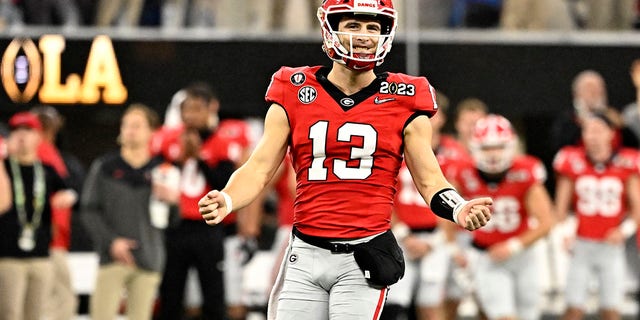 Quarterback Stetson Bennett #13 of the Georgia Bulldogs reacts after a touchdown against the TCU Horned Frogs in the first half in the CFP National Championship Football game at SoFi Stadium in Inglewood on Monday, January 9, 2023. 