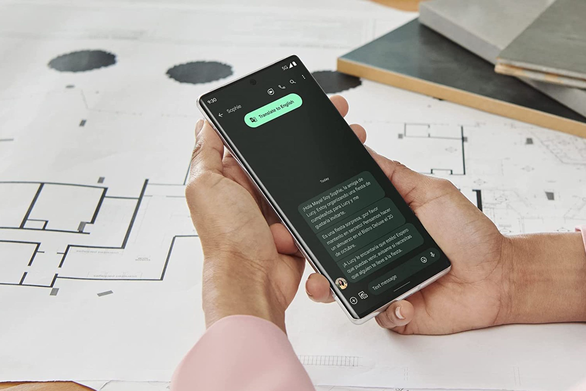 A hand holding a black Google Pixel 6 Pro phone, which is turned on.