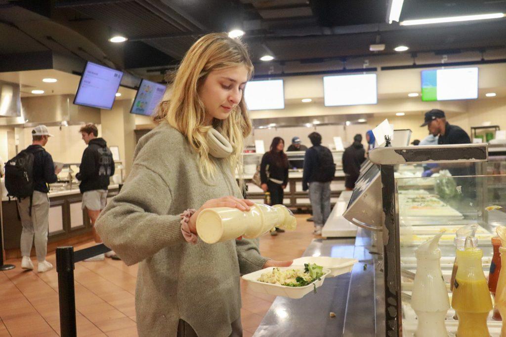 Torgerson creates a nutrition-packed salad in the Pepperdine Caf on Feb. 25. She said she is intentional about listening to her body and honoring cravings.