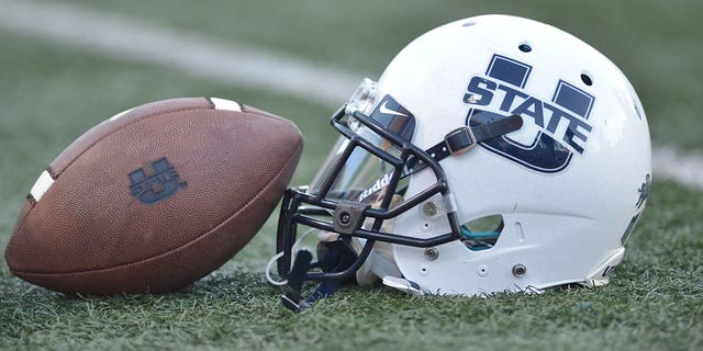 A Utah State Aggies helmet and football prior to the start of a game between the Fresno State Bulldogs and the Utah Aggies.