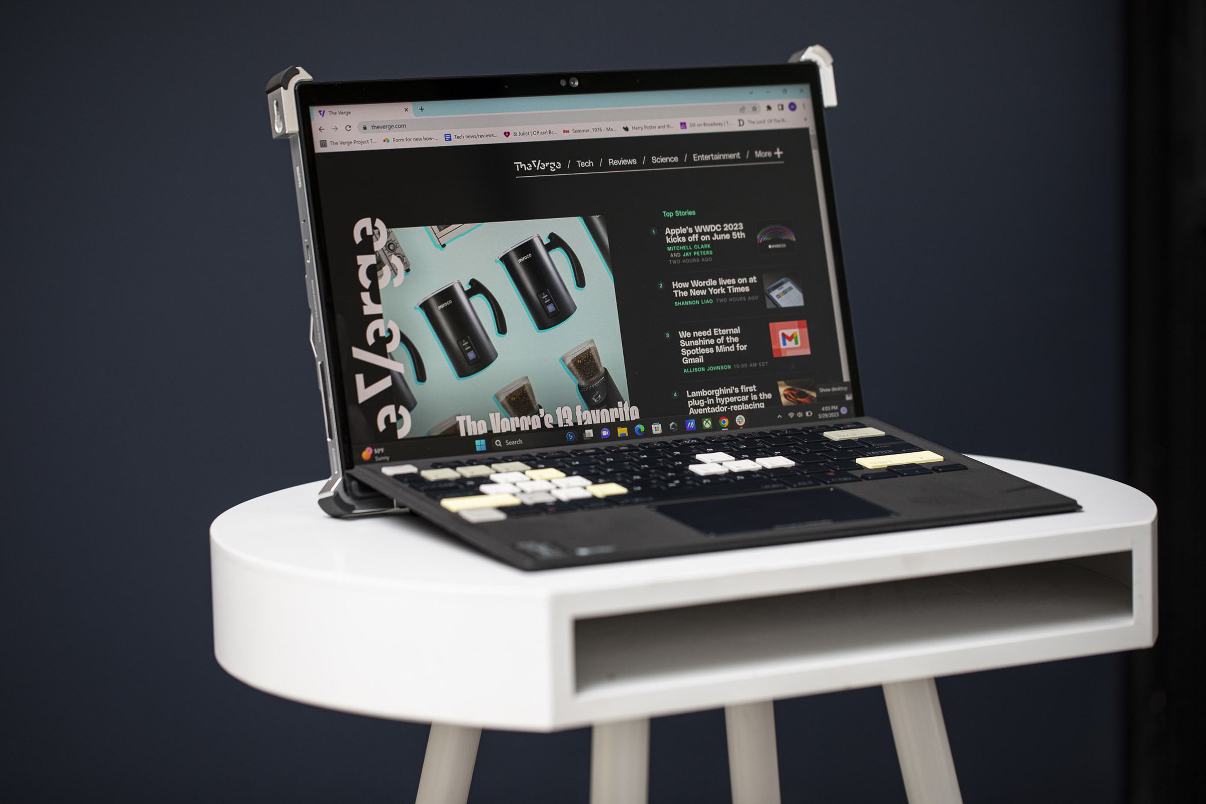 The Asus ROG Flow Z13 in laptop mode angled to the right seen from the front on a white table.