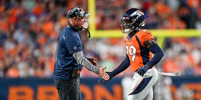 Head coach Nathaniel Hackett of the Denver Broncos congratulates cornerback Faion Hicks #29 after a play against the Minnesota Vikings in a preseason game at Empower Field at Mile High on August 27, 2022 in Denver, Colorado.
