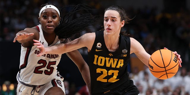 Caitlin Clark (22) of the Iowa Hawkeyes dribbles against Raven Johnson (25) of the South Carolina Gamecocks during the third quarter of the 2023 NCAA Tournament Final Four at American Airlines Center March 31, 2023, in Dallas, Texas.