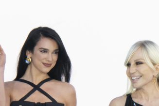 Dua Lipa Debuts Her Versace Collection In a Cutout Buckled Dress With Celeb Guestlist