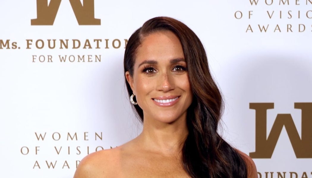 Meghan Markle’s Gold Strapless Cutout Dress Is One of her Boldest Looks Yet