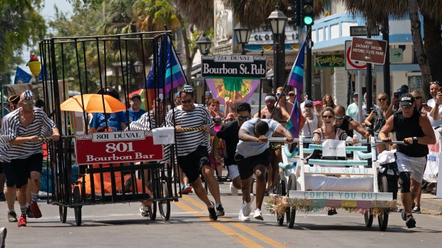 Participants in the Conch Republic Bed Race roll their entries down Duval Street, Saturday, April 29, 2023, in Key West, Fla. The wacky race, billed as "the most fun you can have in bed with your clothes on," was part of the island city's annual Conch Republic Independence Celebration that commemorates the Florida Keys' symbolic 1982 secession from the United States. (Photo by Rob O'Neal, Florida Keys News Bureau via AP)