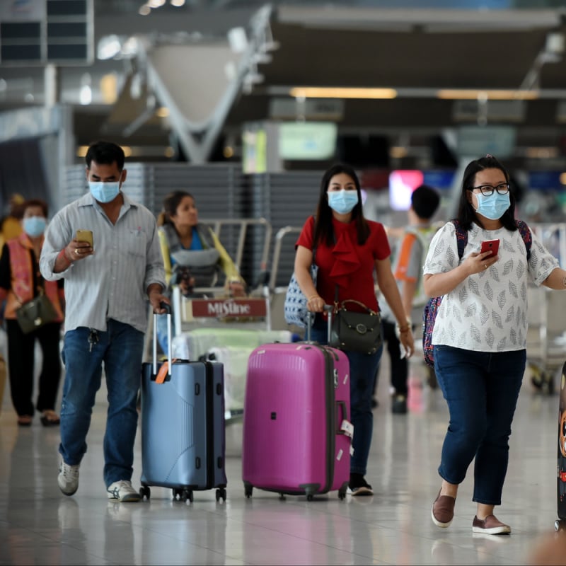 asian travelers with masks