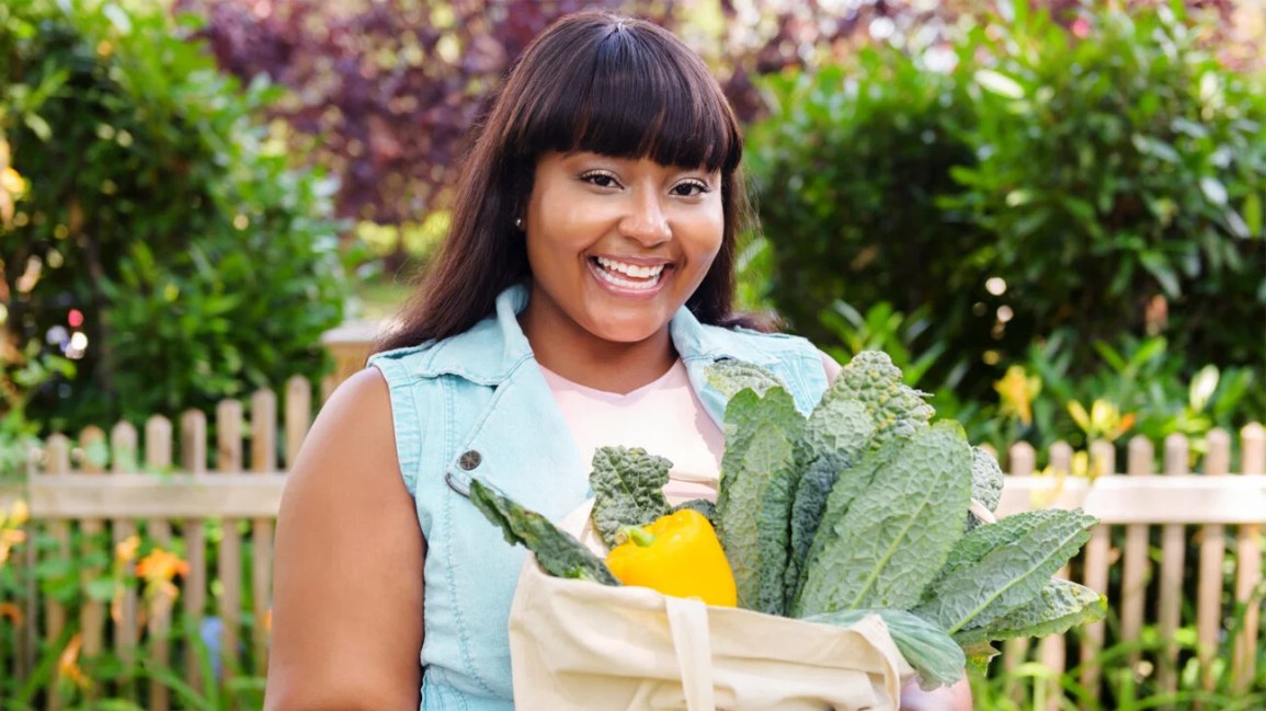 A woman holding a bag of groceries.