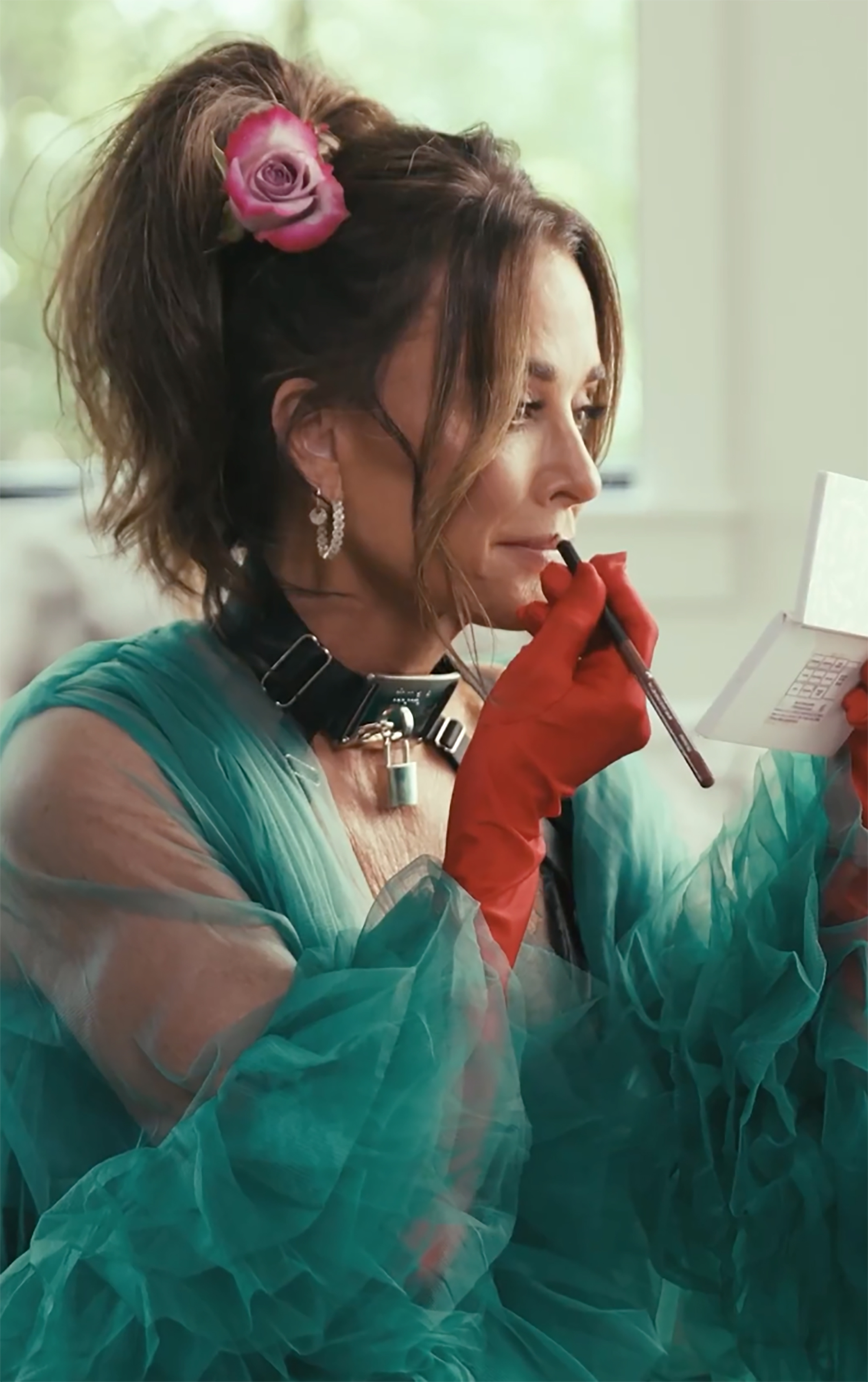 Kyle Richards putting on lipstick