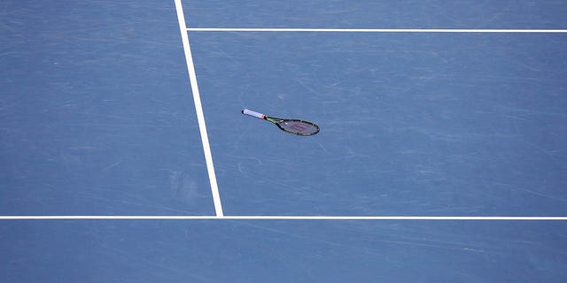 tennis racket on a hard court