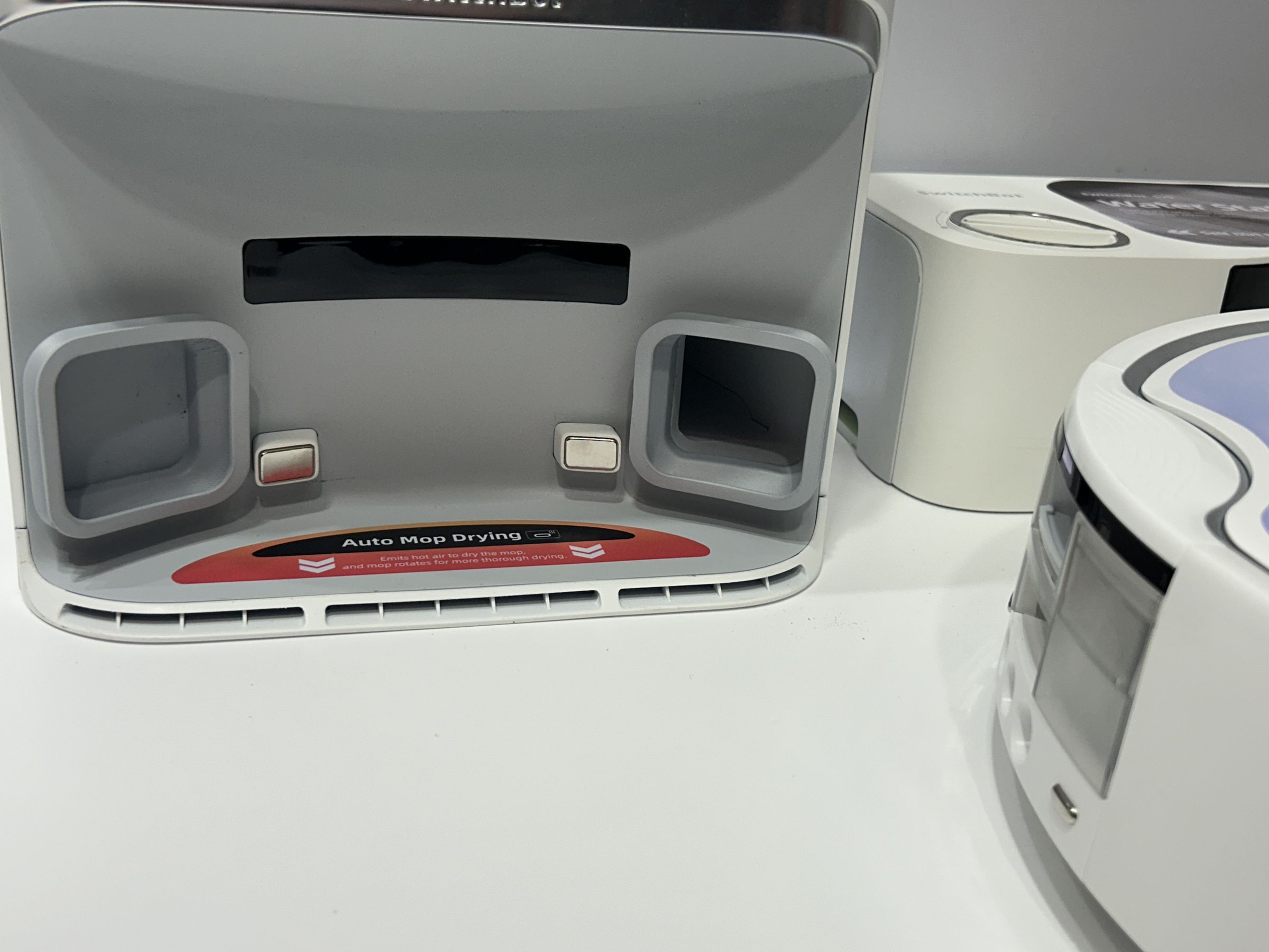 These vents on the bottom of the SwitchBot auto-empty dock blow hot air on the mop when the vacuum is docked.