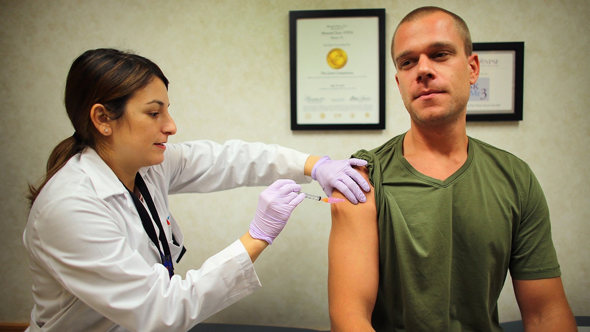doctor gives flu vaccination