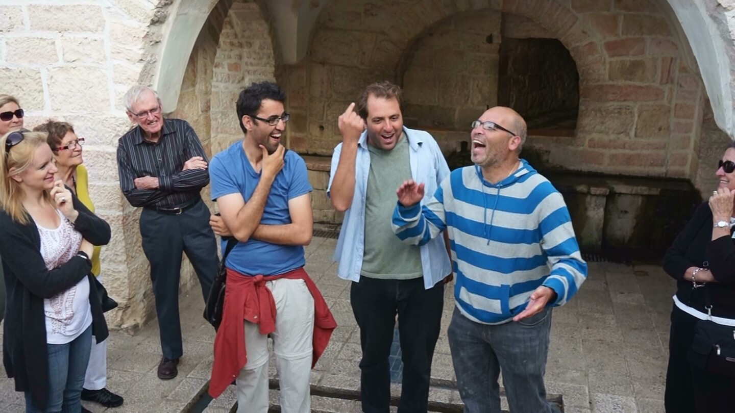 Aziz Abu Sarah (in a blue t-shirt) with two guides in Israel