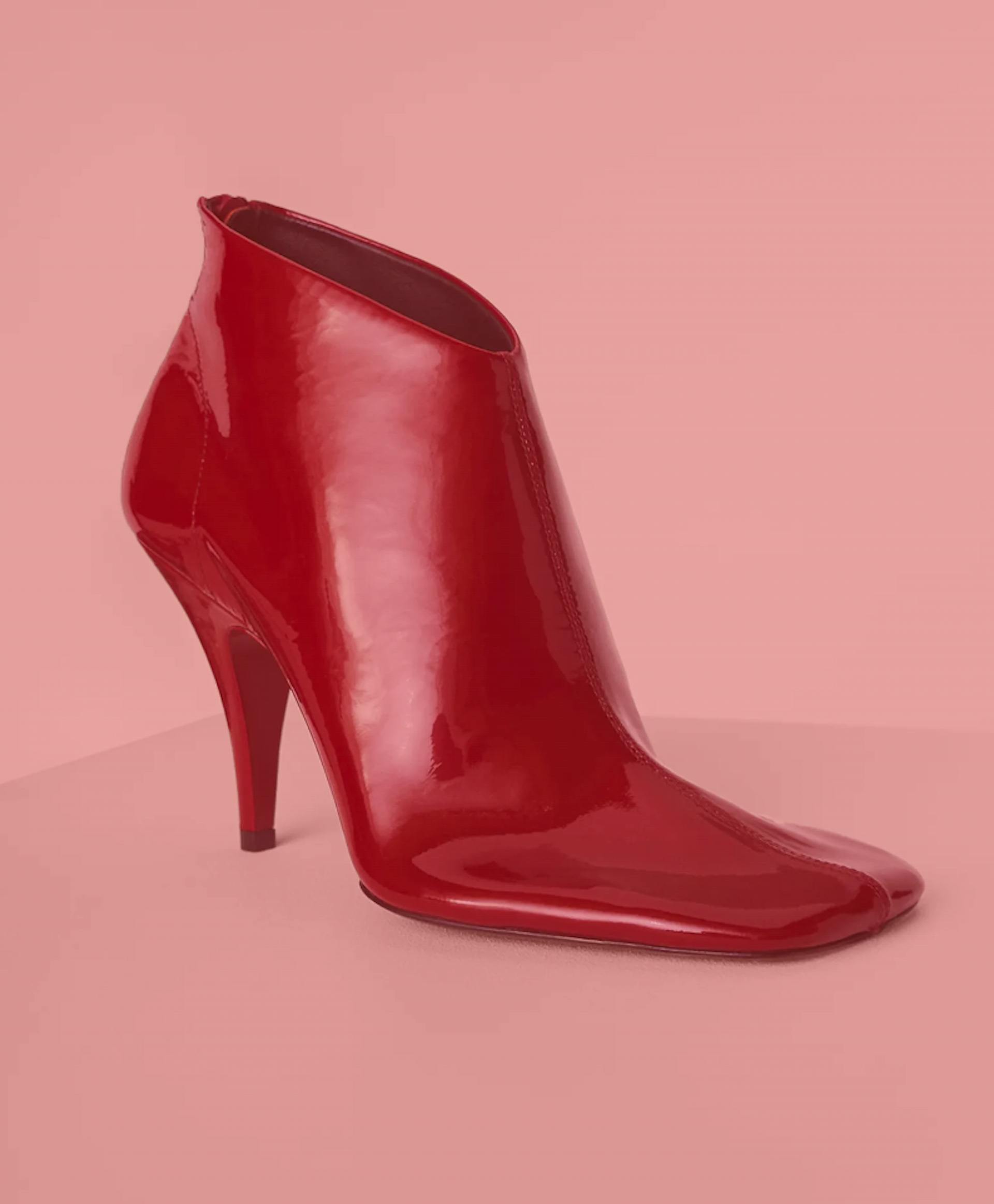 A single red ankle boot with a blunt square toe.