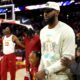 LeBron James faces scrutiny for entering USC arena while national anthem plays, sitting down as song plays