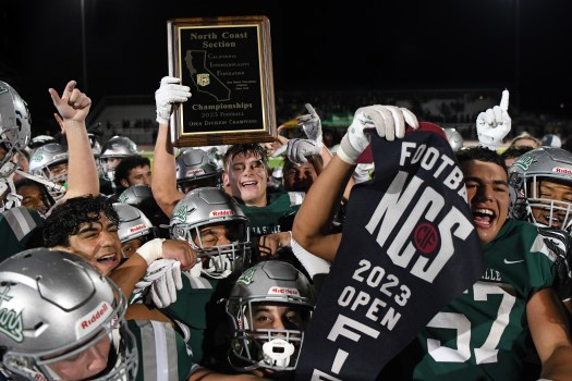 De La Salle’s Drew Cunningham (35) holds the first place plaque after defeating San Ramon Valley during their North Coast Section Open Division championship game at Dublin High School in Dublin, Calif., on Friday, Nov. 17, 2023. De La Salle defeated San Ramon Valley 17-7 to win it’s 31st consecutive NCS title. (Jose Carlos Fajardo/Bay Area News Group)