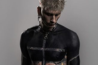 Machine Gun Kelly gets "spiritual" blackout tattoo on upper torso