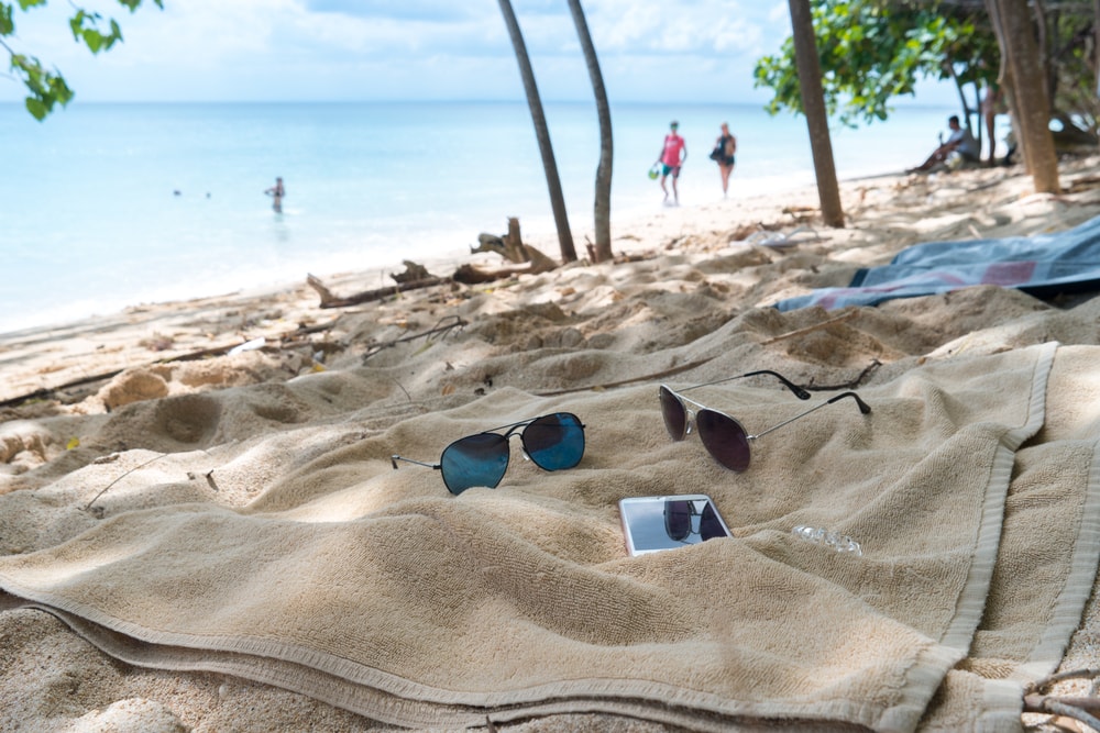 Sunglasses and cell phone on a beach in the yucatan state
