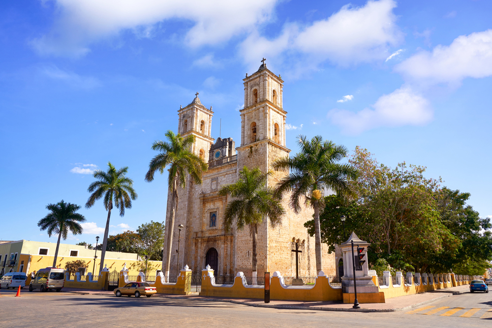 Valladolid Cathedral in the Yucatan with blue skies and palm trees