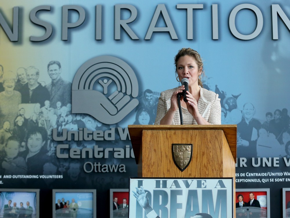 Sophie Grégoire Trudeau stands behind a podium speaking into a microphone