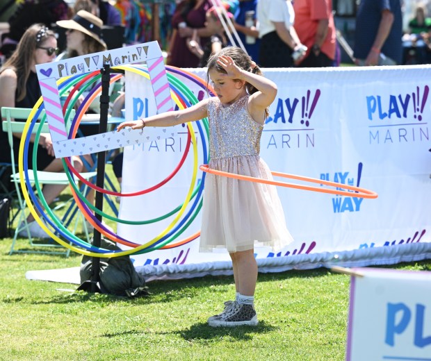 Audrey Warner, 6, of San Francisco works on her Hoola...