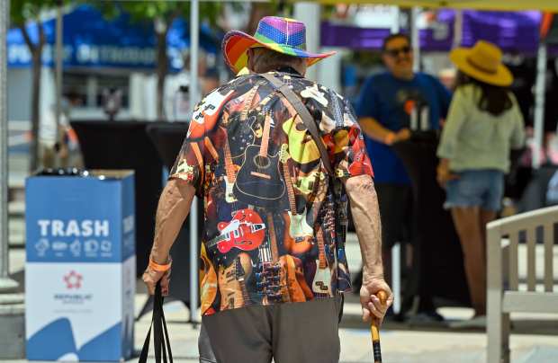 A visitor wears a music-inspired shirt as Chad Martini performs...