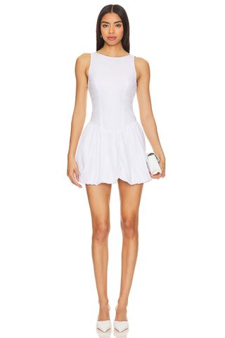 a model wears a white sleeveless dress with a bubble hem