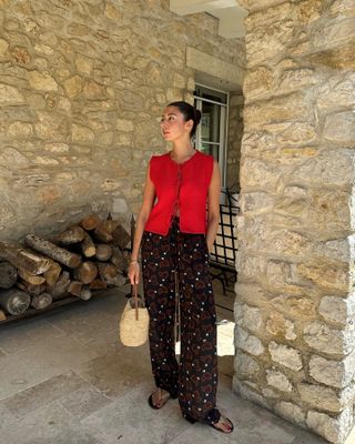 Woman wearing a red top and black pants