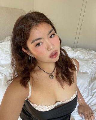 Allison Ho with wavy mahogany hair.