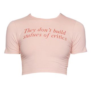 a pink cropped T-shirt that says