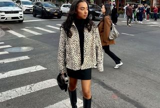 Woman wearing a leopard jacket and miniskirt.