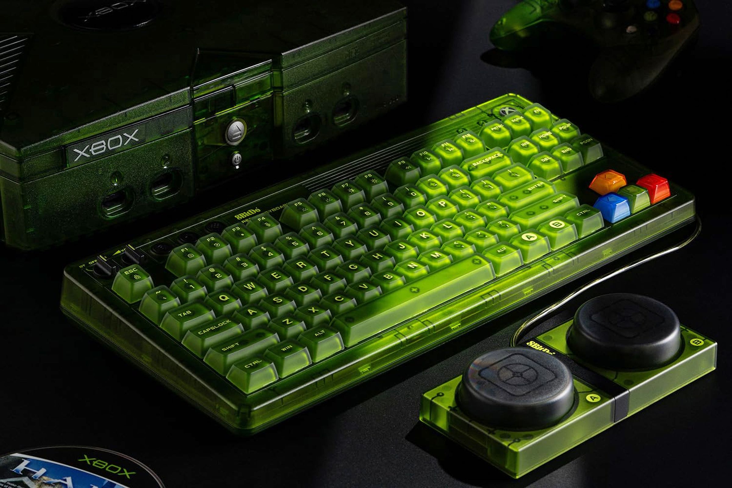 8BitDo’s green Xbox-themed Retro 87 Mechanical Keyboard in front of a matching green Xbox console.