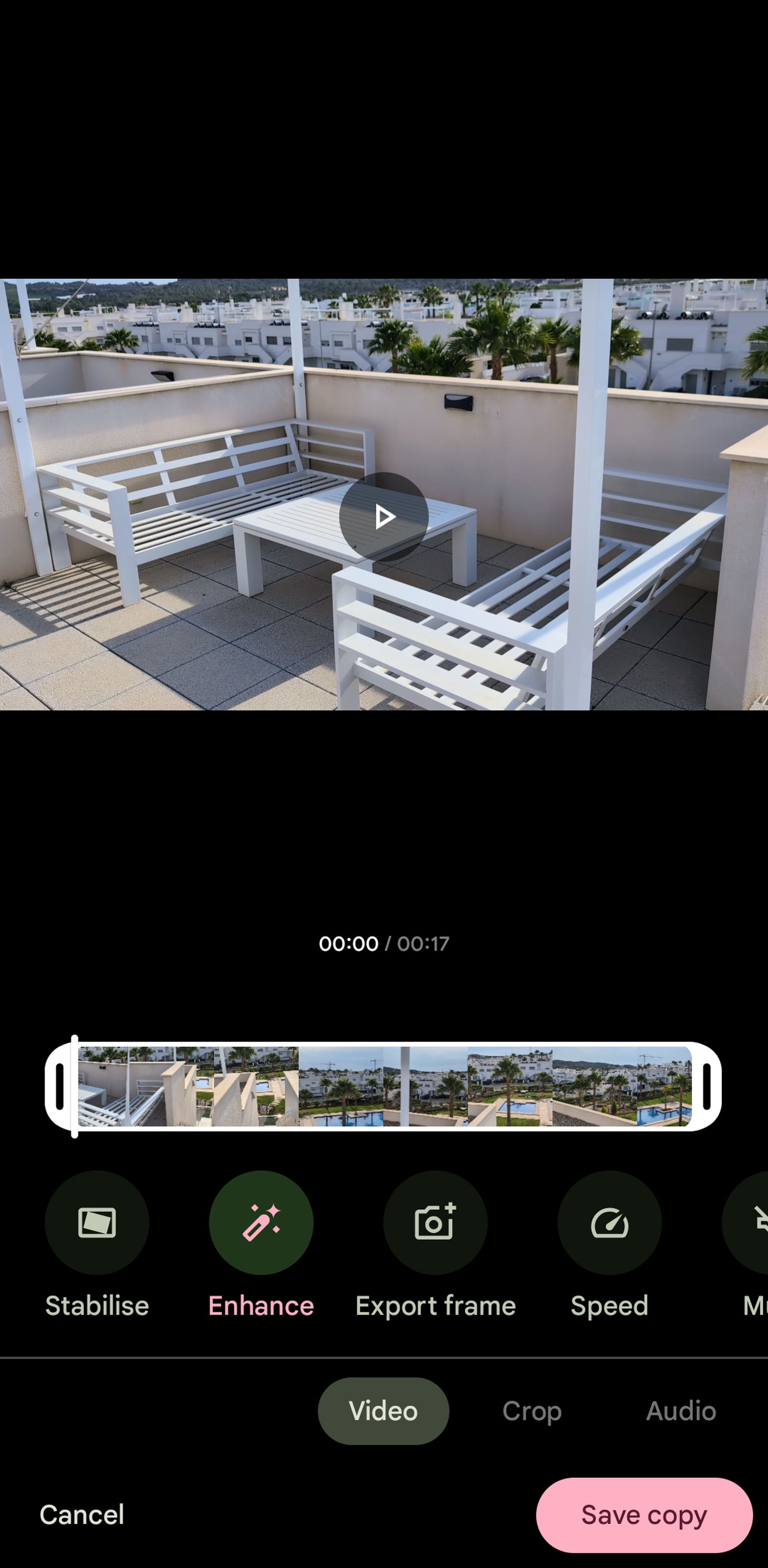 Google Photos screen with photo on top and auto-enhancement icon highlighted on bottom.