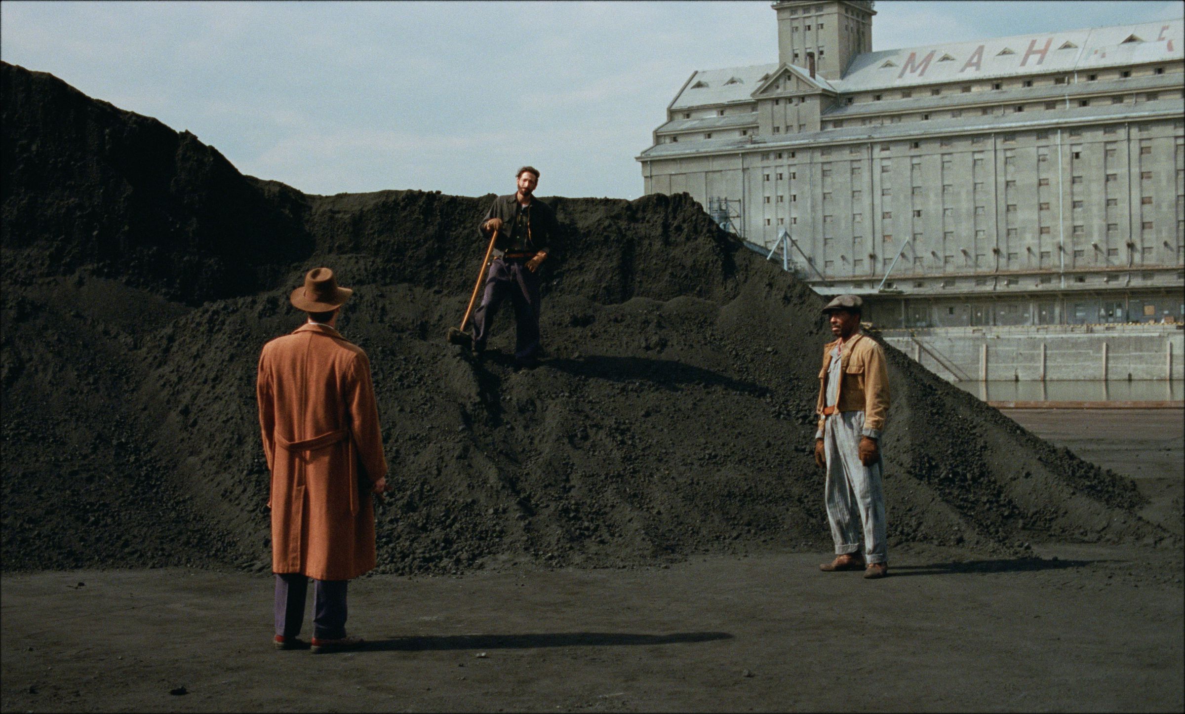 A still of actors Guy Pearce, Adrien Brody, and Isaach De Bankolé in The Brutalist
