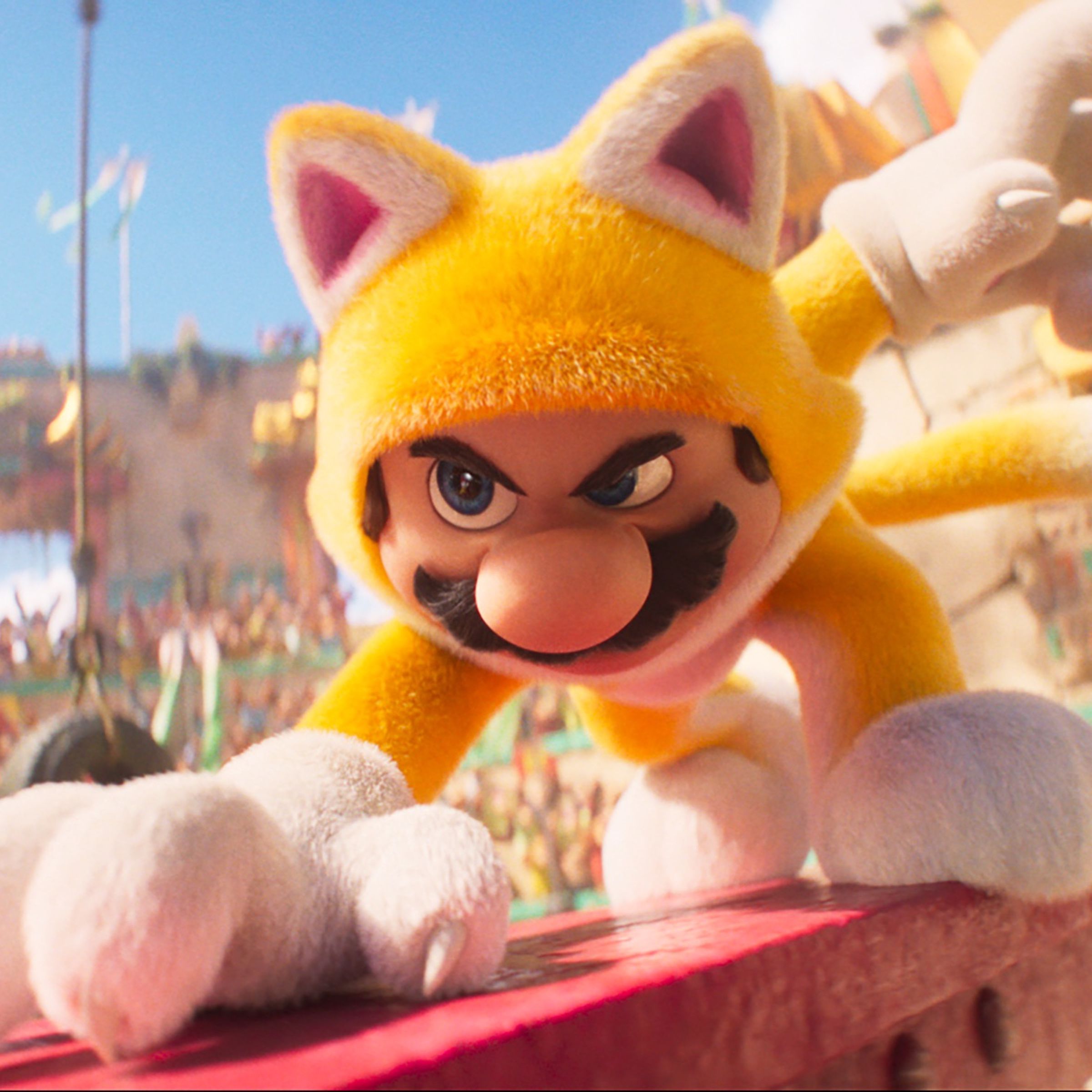 A man wearing a full body suit that makes him look like a fuzzy yellow cat and crouching on a steel beam in the middle of a colosseum.