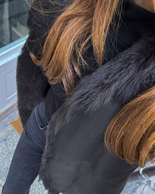 Woman wearing all-black skinny jeans outfit.