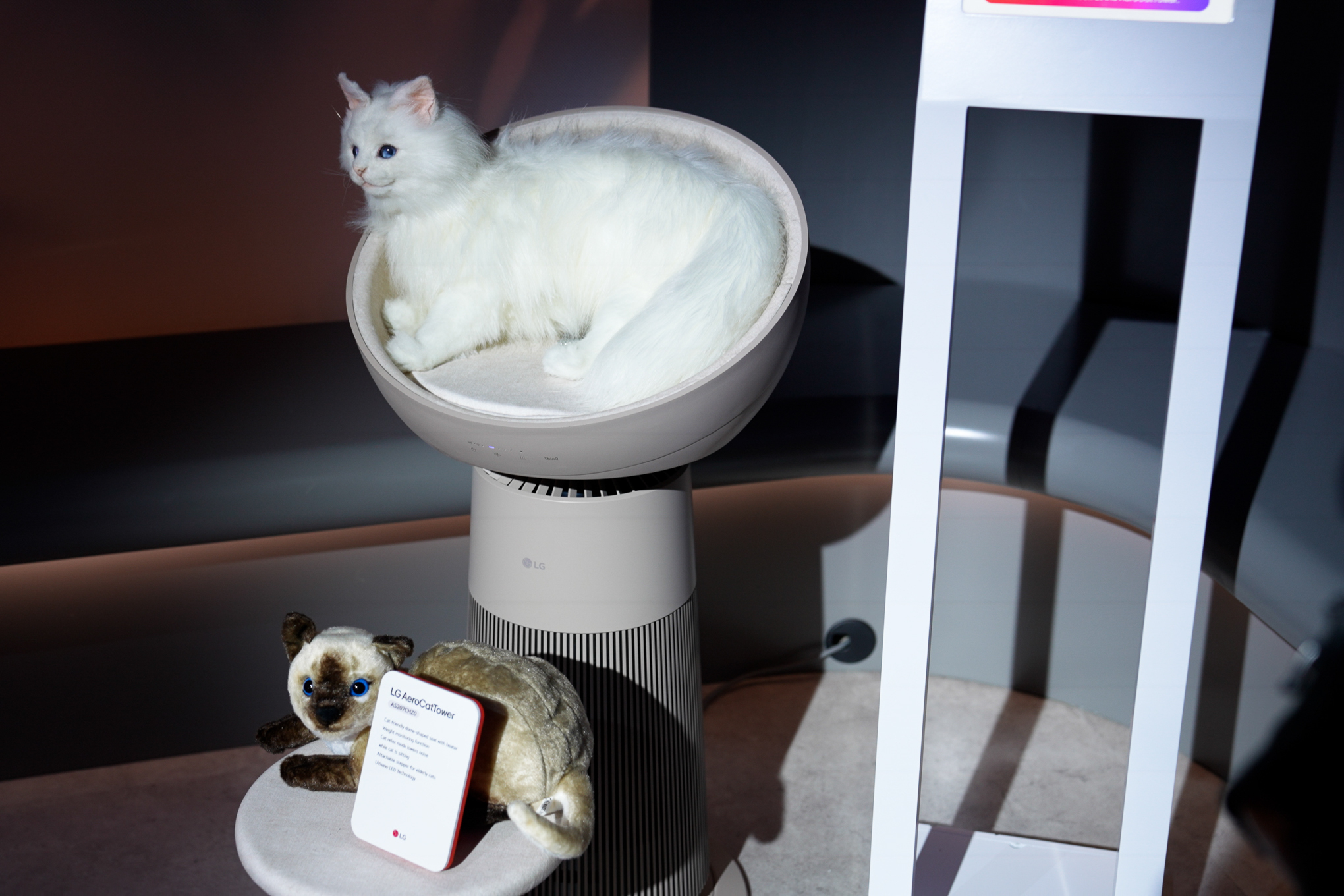 Stuffed cats sitting on LG’s cat tree air purifier.