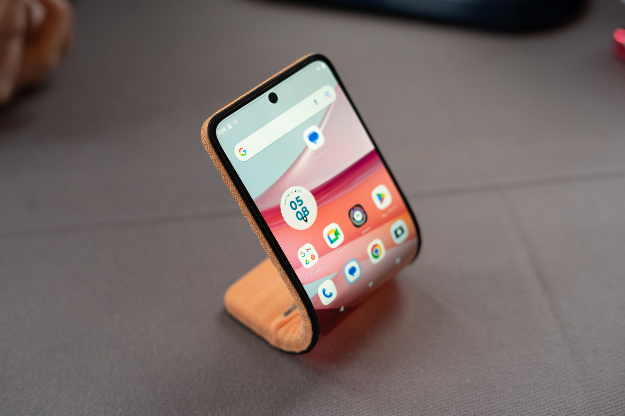 Motorola’s bending phone concept, curved and sitting on a table.