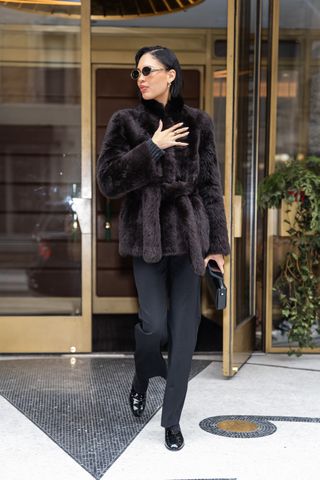 NEW YORK, NEW YORK - FEBRUARY 02: Nara Smith is seen in SoHo on February 02, 2025 in New York City wearing a fur coat, black trousers, and patent leather Chanel flats.
